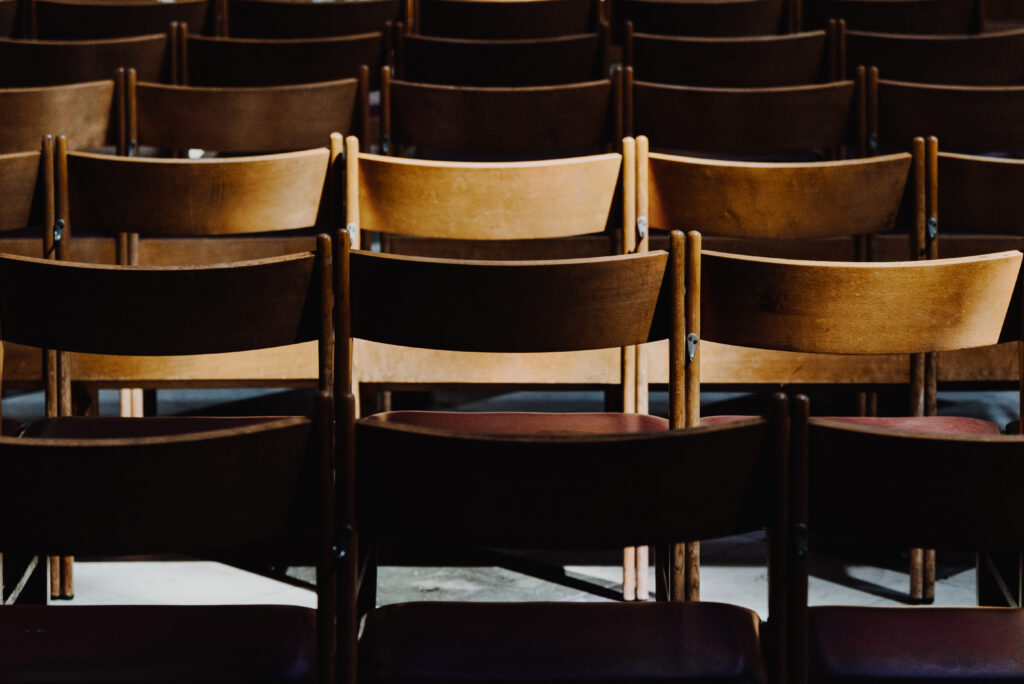 Sun highlighting a wooden chair in the church